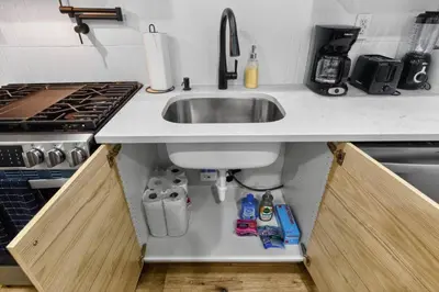 a kitchen counter with a sink and a stove at Brand New 2BR in the Heart of Center City that Sleeps 14 people in Philadelphia