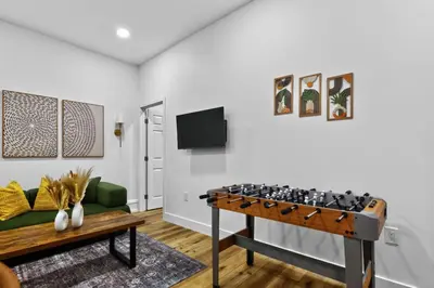 a living room with a ping pong table at Brand New 2BR in the Heart of Center City that Sleeps 14 people in Philadelphia