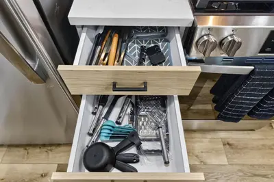 an open drawer in a refrigerator filled with utensils at Brand New 2BR in the Heart of Center City that Sleeps 14 people in Philadelphia