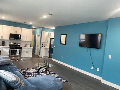 a living room with a couch and a blue wall at Peace Haven Stay in Newark