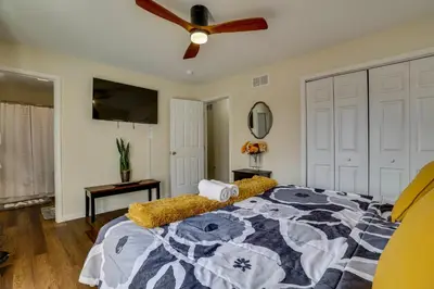 a bedroom with a bed and a ceiling fan at Lakefront Pocono Retreat with Hot Tub and Movie Hub in Pocono Summit
