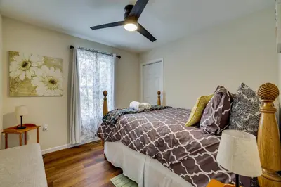 a bedroom with a bed and a ceiling fan at Lakefront Pocono Retreat with Hot Tub and Movie Hub in Pocono Summit