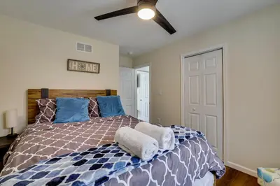 a bedroom with a bed and a ceiling fan at Lakefront Pocono Retreat with Hot Tub and Movie Hub in Pocono Summit