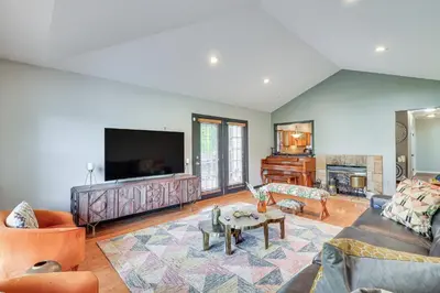 a living room with a couch and a tv at 5 Mi to Princeton Family Home with Deck and Yard! in Dutch Neck