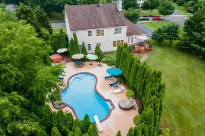 an aerial view of a house with a swimming pool at 5 Mi to Princeton Family Home with Deck and Yard! in Dutch Neck