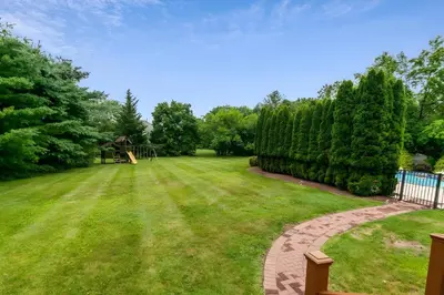 a yard with a playground in the background at 5 Mi to Princeton Family Home with Deck and Yard! in Dutch Neck