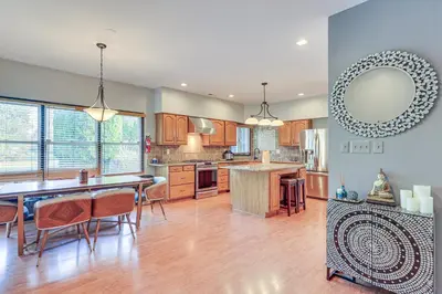 a large kitchen with a table and chairs and a counter at 5 Mi to Princeton Family Home with Deck and Yard! in Dutch Neck