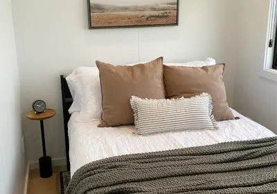 a bed with two pillows and a blanket on it at Scenic Ridge Haven Firepit, Trails & Views
