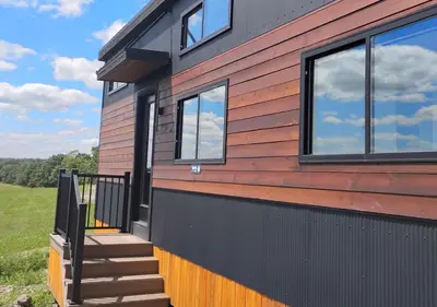 a house with a staircase and windows on it at Scenic Ridge Haven Firepit, Trails & Views