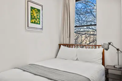 a bedroom with a bed and a window at Carroll Place - Bright 3BR Apt in Carroll Gardens in Brooklyn