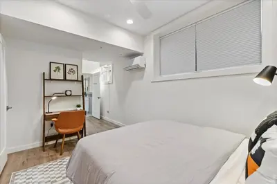 a bedroom with a bed and a desk and a window at Modern Princeton Stay Steps from Nassau Street in Princeton