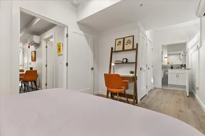 a white bedroom with a bed and a dining room at Modern Princeton Stay Steps from Nassau Street in Princeton