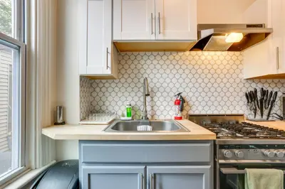 a kitchen with a sink and a stove at Explore and Work! Stylish Washington Heights Duplex in Newburgh