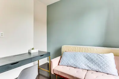 a room with a pink chair and a desk at Explore and Work! Stylish Washington Heights Duplex in Newburgh