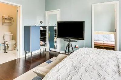 a bedroom with a bed and a tv in it at Explore and Work! Stylish Washington Heights Duplex in Newburgh
