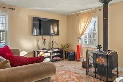 a living room with a couch and a fireplace at InDoor HotTub Pocono Mountains Home