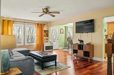 a living room with a couch and a flat screen tv at InDoor HotTub Pocono Mountains Home