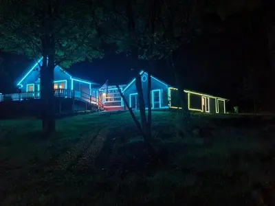 a house with lights on it at night at InDoor HotTub Pocono Mountains Home
