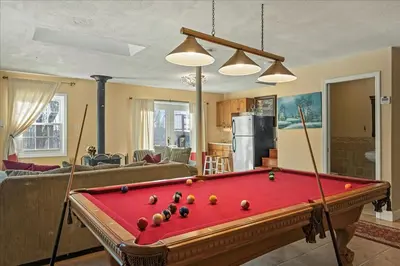a living room with a pool table in a living room at InDoor HotTub Pocono Mountains Home