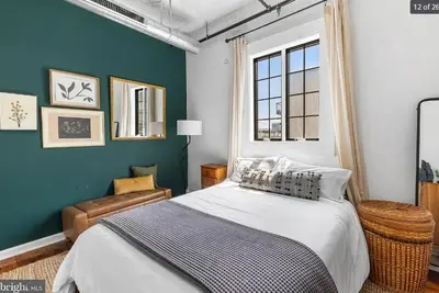 a bedroom with a bed and a blue wall at Charming Retreat in Trendy NoLibs in Philadelphia