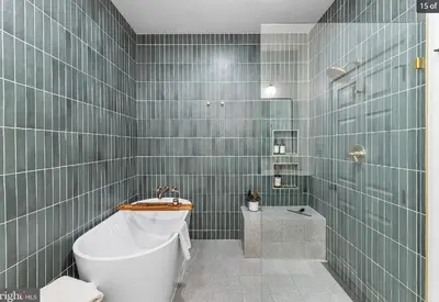 a bathroom with a tub and a toilet and a sink at Charming Retreat in Trendy NoLibs in Philadelphia