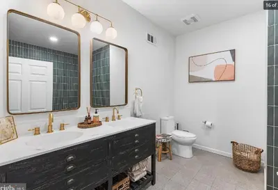 a bathroom with a sink and a mirror and a toilet at Charming Retreat in Trendy NoLibs in Philadelphia