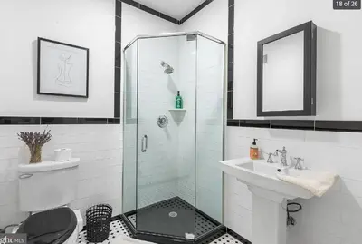 a bathroom with a shower and a toilet and a sink at Charming Retreat in Trendy NoLibs in Philadelphia