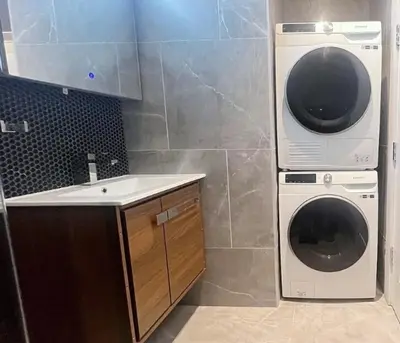 a kitchen with a washing machine and a sink at Duplex Dream 4-Bedroom Bonbon in New York