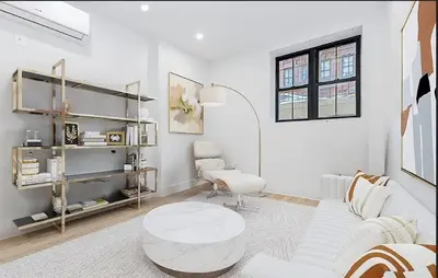 a white living room with a white couch and a table at Duplex Dream 4-Bedroom Bonbon in New York