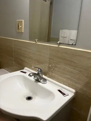 a bathroom with a white sink and a mirror at Hollywood Motel in Middletown