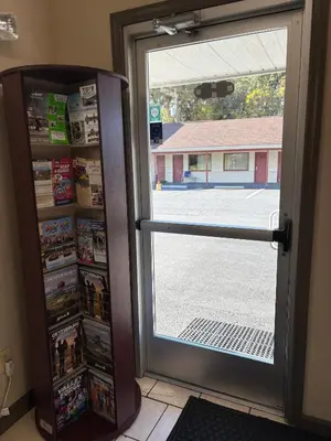 a door to a store with a view of a building at Hollywood Motel in Middletown
