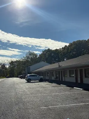 a car parked in a parking lot next to a building at Hollywood Motel in Middletown