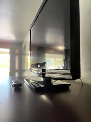 a tv sitting on a table with a remote control at Hollywood Motel in Middletown