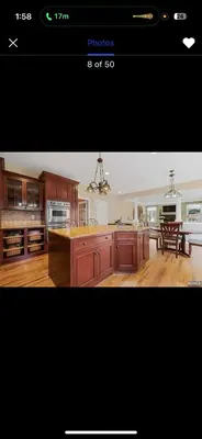 a kitchen with wooden cabinets and a kitchen island at villa in North Haledon