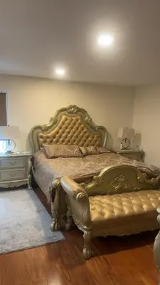 a bedroom with a large bed and a couch at villa in North Haledon