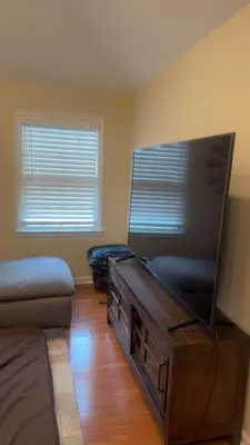 a living room with a large flat screen tv at villa in North Haledon