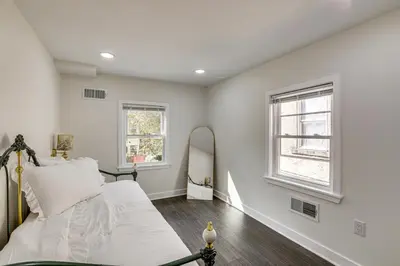a white bedroom with a bed and a mirror at Updated Gem! Walk to Fishtown, 3 Mi to Center City in Philadelphia
