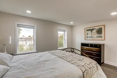 a bedroom with a large bed and two windows at Updated Gem! Walk to Fishtown, 3 Mi to Center City in Philadelphia