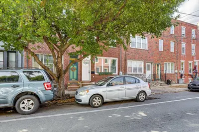 two cars parked next to a tree in front of a building at Updated Gem! Walk to Fishtown, 3 Mi to Center City in Philadelphia