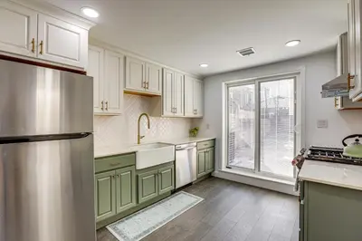 a kitchen with white cabinets and a stainless steel refrigerator at Updated Gem! Walk to Fishtown, 3 Mi to Center City in Philadelphia