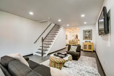 a living room with a couch and a staircase at Updated Gem! Walk to Fishtown, 3 Mi to Center City in Philadelphia