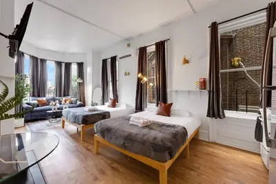 a living room with two beds and a couch at New Studio in Center City that Sleeps 4 with Fast Wifi in Philadelphia