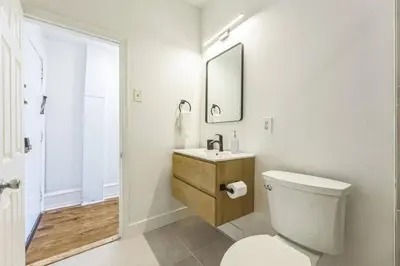 a bathroom with a toilet and a sink and a mirror at New Studio in Center City that Sleeps 4 with Fast Wifi in Philadelphia