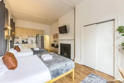 a large bedroom with two beds and a kitchen at New Studio in Center City that Sleeps 4 with Fast Wifi in Philadelphia