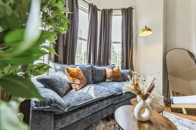 a living room with a blue couch and a table at New Studio in Center City that Sleeps 4 with Fast Wifi in Philadelphia