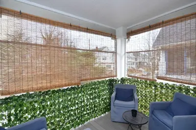 a room with two chairs and a wall of green plants at Cozy Beds with Parking, Laundry - Near RU, RWJ, NJ Transit in Highland Park
