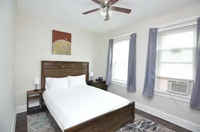 a bedroom with a bed and a ceiling fan at Spacious Home with Parking, Laundry - Near RU, RWJ, NJ Transit in Highland Park