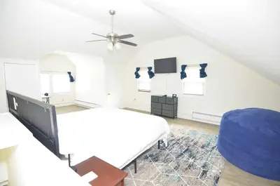 a bedroom with a bed and a ceiling fan at Cozy Beds with Parking, Laundry - Near RU, RWJ, NJ Transit in Highland Park