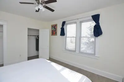 a bedroom with a bed and a ceiling fan at Cozy Beds with Parking, Laundry - Near RU, RWJ, NJ Transit in Highland Park