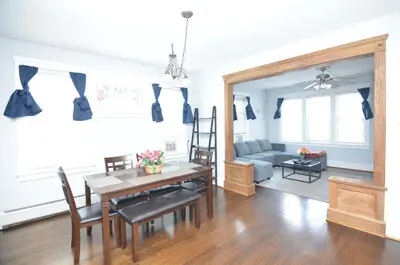 a living room with a table and a couch at Spacious Home with Parking, Laundry - Near RU, RWJ, NJ Transit in Highland Park